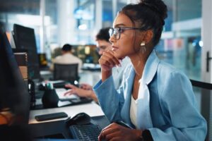Female programmer on computer creating innovative solutions.