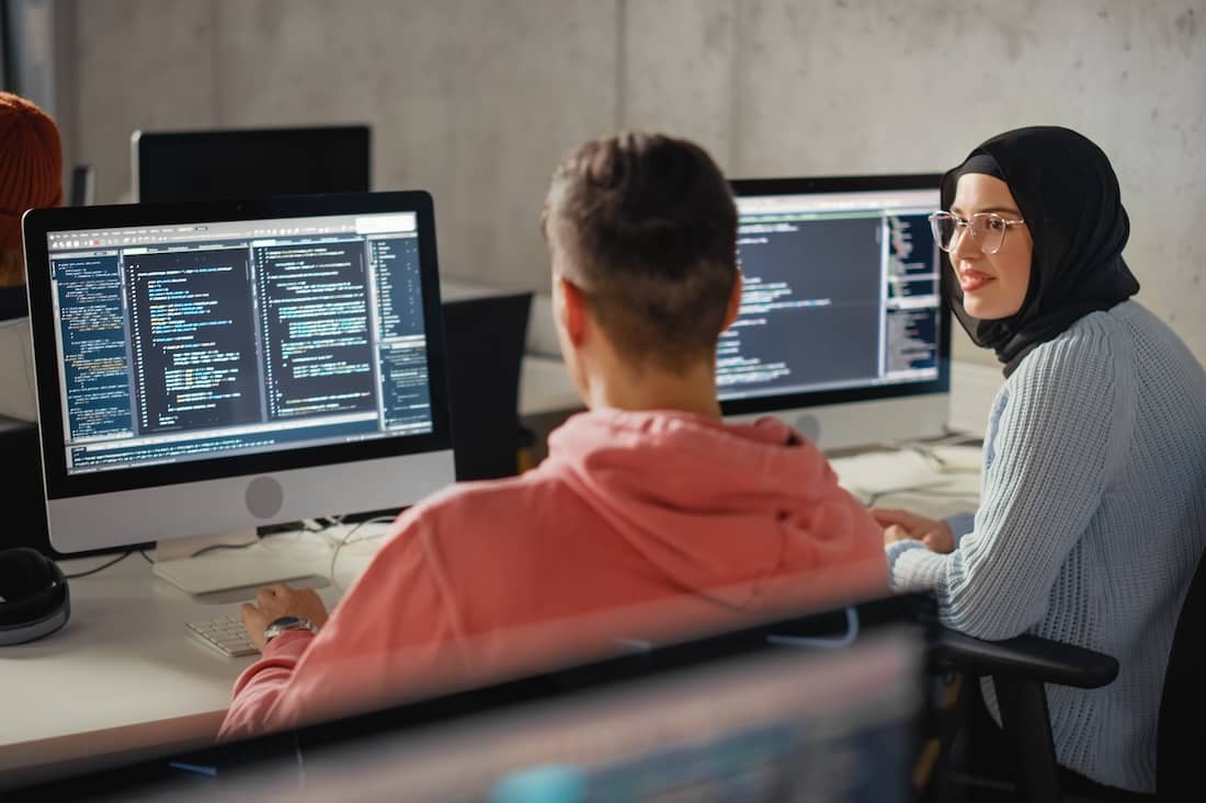Students Collaborate in College Room on Computer Science Project