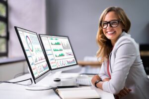 Female Analyst Looking At Business Data Analytics Dashboard