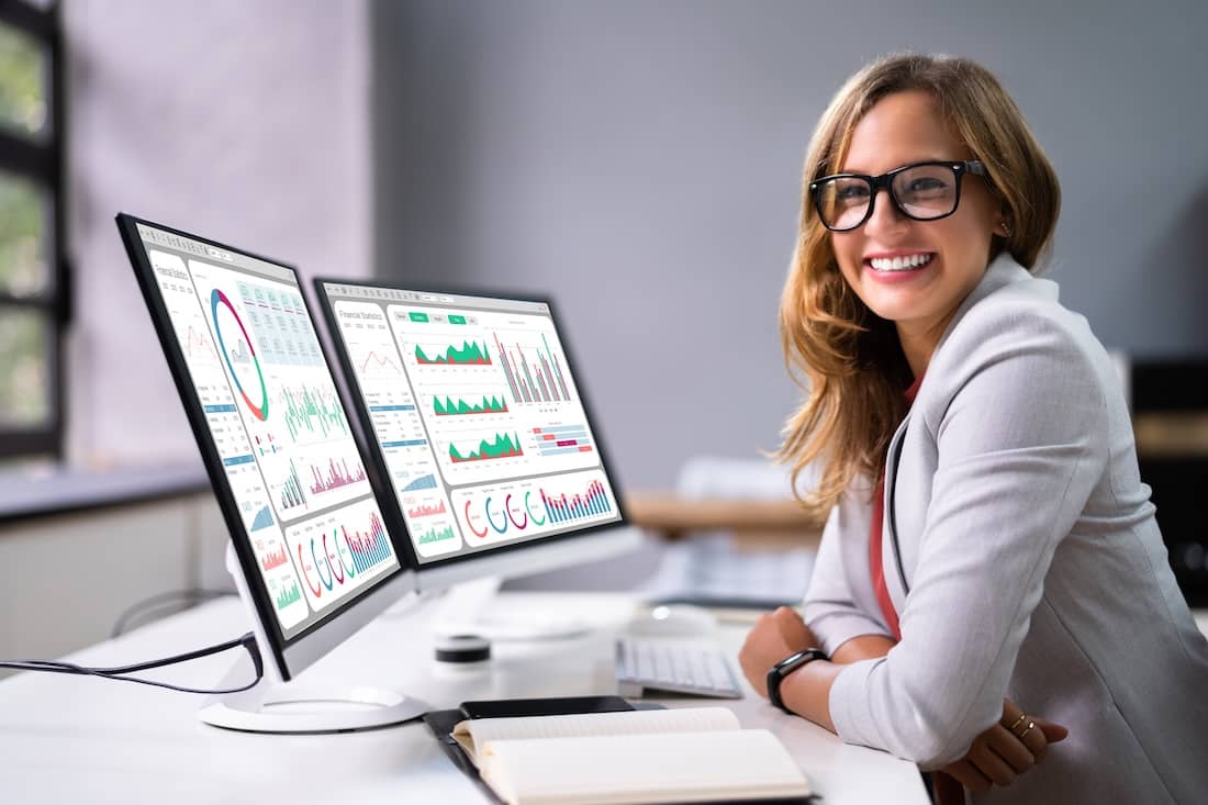 Female Analyst Looking At Business Data Analytics Dashboard