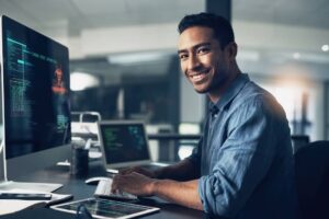 Portrait of a man using a computer in a modern office.